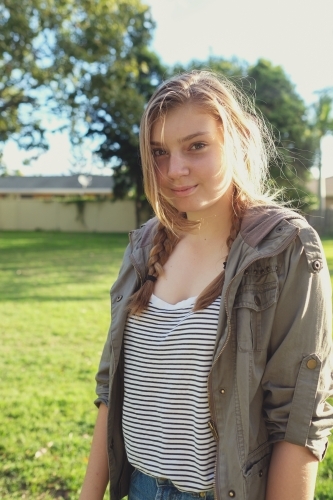Happy teenage girl in the park - Australian Stock Image