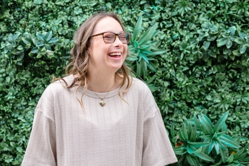 happy woman, from a series featuring a young woman with Down Syndrome - Australian Stock Image