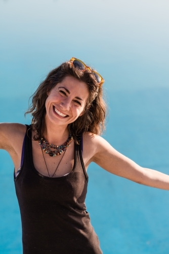 happy woman with arms outstretched - Australian Stock Image