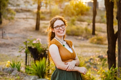 Happy young australian woman in her twenties wearing green and gold - Australian Stock Image