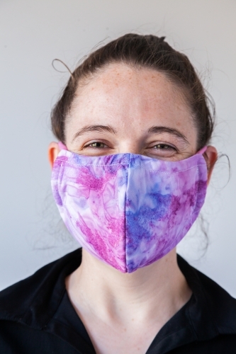 Happy young business woman in covid mask on white