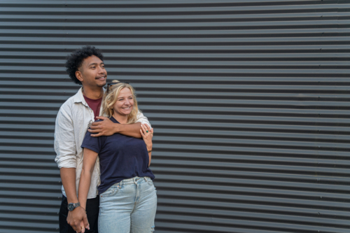 happy young couple smiling and hugging - Australian Stock Image