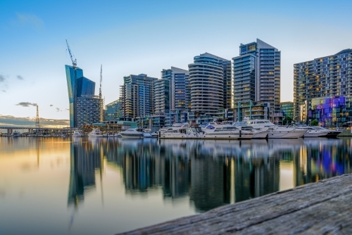 Harbour view with modern buildings and reflections at sunset, in Docklands, Melbourne - Australian Stock Image