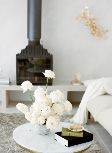 Having Afternoon Tea in Pretty Living Room with White Furnitures and Fire Place and White Roses