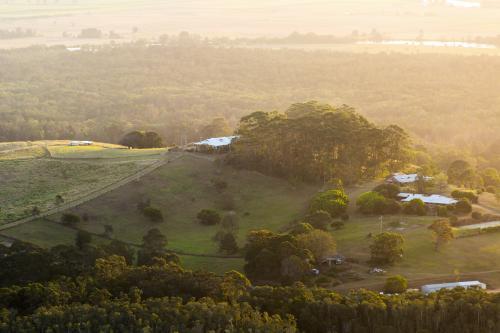 Haze over landscape of country farm house at sunset