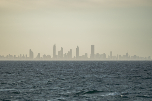 Hazy cityscape in a distant under overcast sky - Australian Stock Image