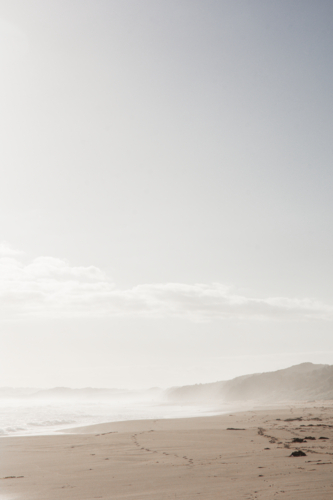 Hazy surf beach with blue sky - Australian Stock Image