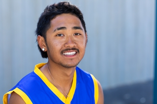 head and shoulders of teenage boy wearing jersey shirt - Australian Stock Image