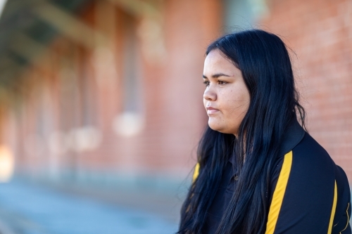 head and shoulders of teenage girl looking across frame - Australian Stock Image