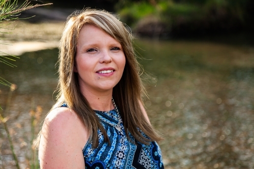 Head and shoulders portrait of a woman outdoors - Australian Stock Image
