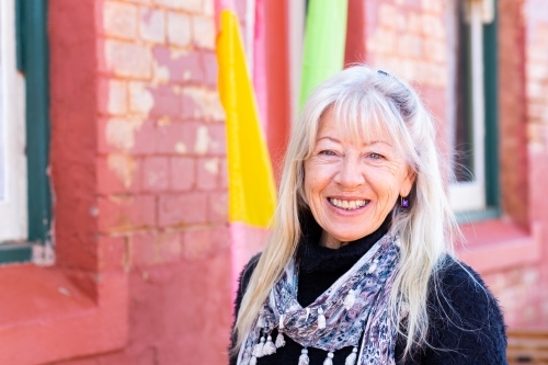 Headshot of mature woman with long hair smiling - Australian Stock Image