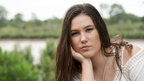 Headshot of pretty girl by the river - Australian Stock Image