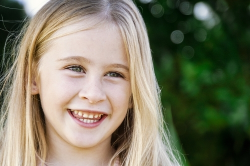 Headshot of six year old smiling looking away - Australian Stock Image
