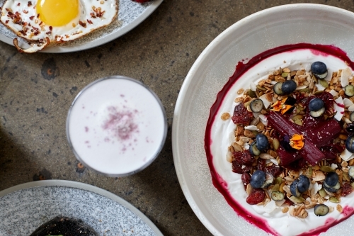 Healthy breakfast cereal with yoghurt and hot beverage - Australian Stock Image