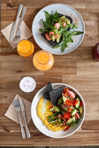 Healthy organic vegan food and drinks on wooden table - Australian Stock Image