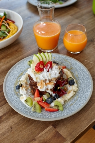 Healthy organic vegan food and drinks on wooden table - Australian Stock Image