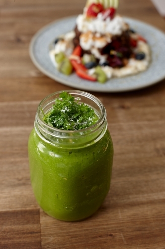 Healthy organic vegan food and drinks on wooden table - Australian Stock Image