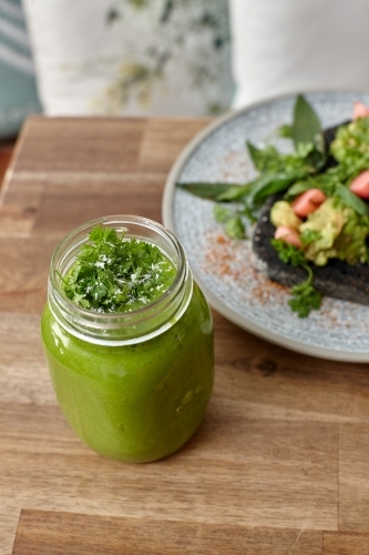 Healthy organic vegan food and drinks on wooden table - Australian Stock Image