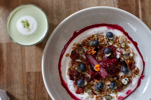 Healthy porridge served with hot beverage in vegetarian cafe