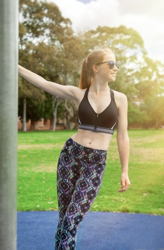 Healthy teenage girl training outdoors - Australian Stock Image