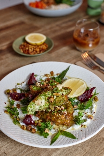 Healthy vegetarian falafel and salad dish on wooden table - Australian Stock Image