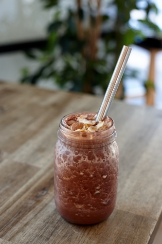 Healthy vegetarian smoothie on wooden table - Australian Stock Image