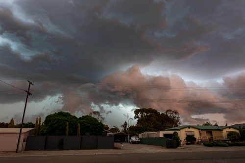 heavy storm clouds over house - Australian Stock Image