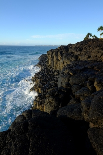 Hexagonal rock formations at Fingal Head - Australian Stock Image