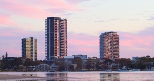 High-rise apartment buildings in Applecross at sunset, with the Swan River in the foreground. - Australian Stock Image