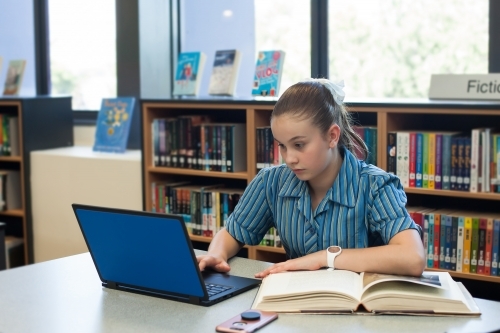 High school student studying in the library - Australian Stock Image