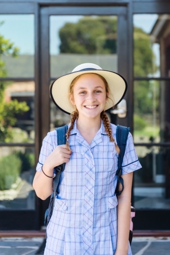 high school student with hat and backpack