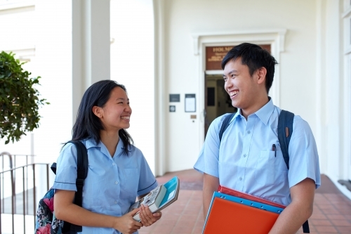 High School students laughing together on-campus - Australian Stock Image