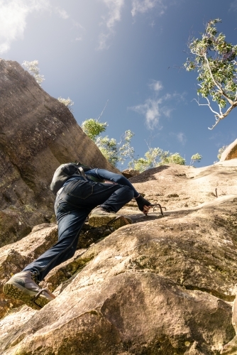 Hiker climbing an escarpment in the Blue Mountains - Australian Stock Image