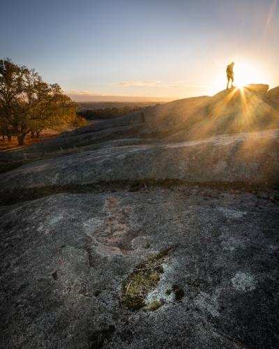 Hiker on a Rocky Peak at Sunrise - Australian Stock Image