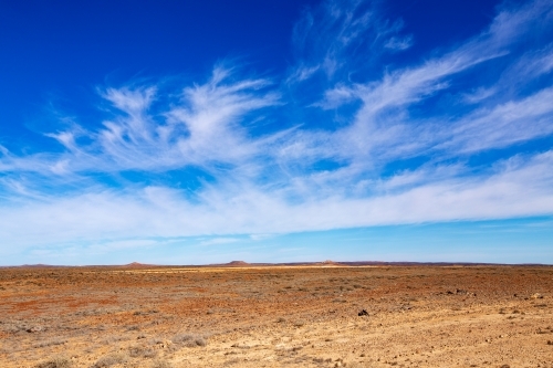 hills on horizon of desert landscape - Australian Stock Image