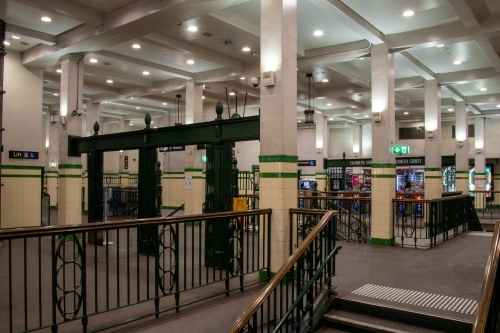 Historic concourse at St James station in Sydney with wrought iron railings and stairs visible
