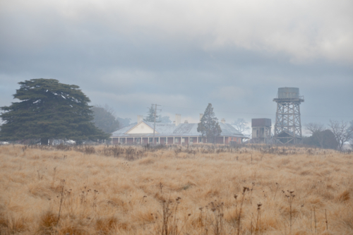 Historic old country home, water tank and a winter morning - Australian Stock Image