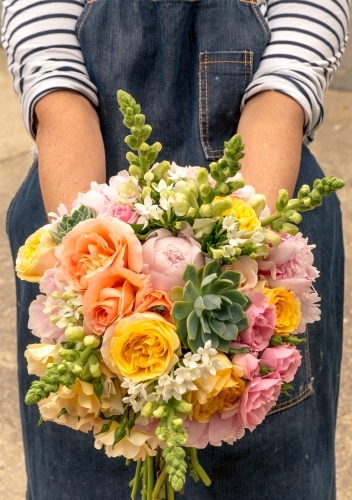 Holding a bouquet of flowers - Australian Stock Image