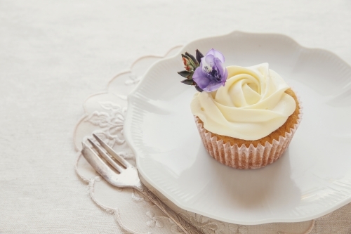 Homemade vintage rose cupcakes with edible flowers - Australian Stock Image