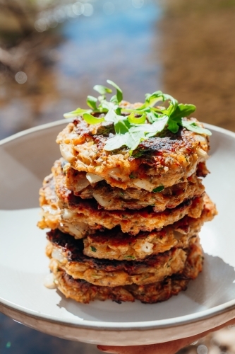Homemade Zucchini fritters next to river - Australian Stock Image