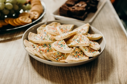 Horizontal shot of a bowl of pikelets sprinkled with colorful hundreds and thousands - Australian Stock Image
