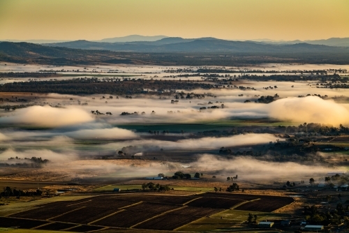 Horizontal shot of a farmland under a cloudy sky - Australian Stock Image