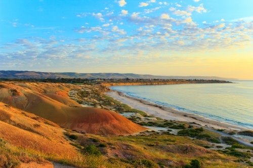 Horizontal shot of a hilly coastline at sunrise - Australian Stock Image