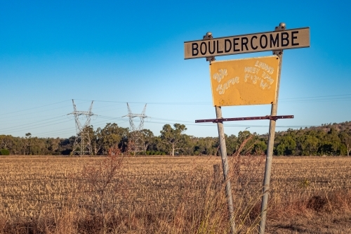 Horizontal shot of a road sign at the side of a grass field - Australian Stock Image