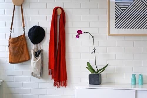 Horizontal shot of a tote bag, scarf and hat hanging on a white wall - Australian Stock Image