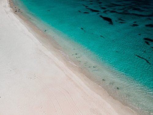 horizontal shot of a white sand beach on a sunny day - Australian Stock Image