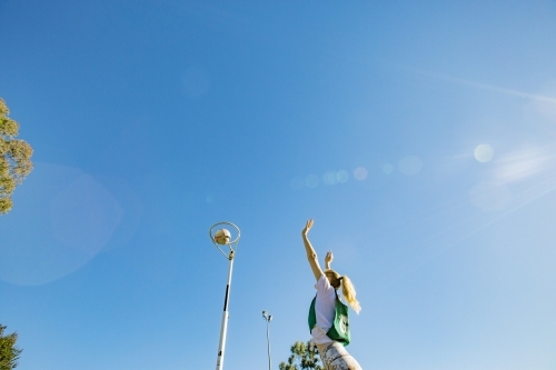 horizontal shot of a young woman celebrating after scoring in a net ball game - Australian Stock Image