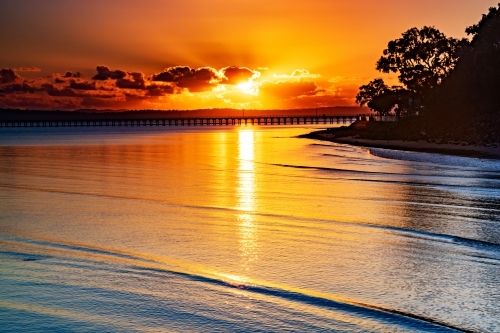 Horizontal shot of an ocean at sunrise - Australian Stock Image