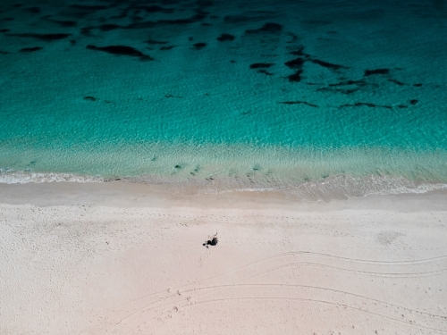 horizontal shot of beach with objects on the white sand on a sunny day - Australian Stock Image