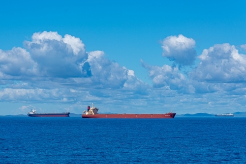 Horizontal shot of cargo ships in the sea - Australian Stock Image